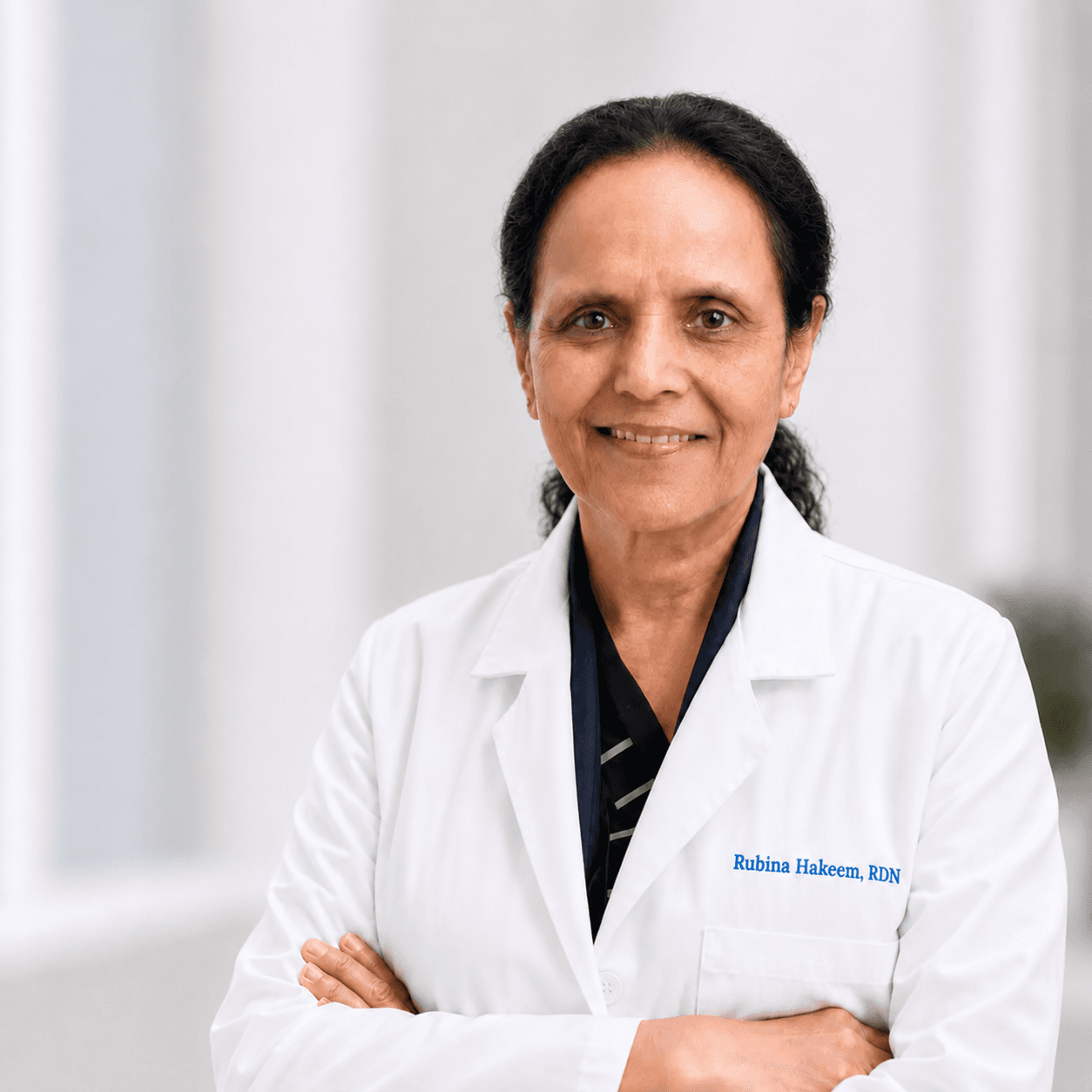 Dr. Rubina Hakeem, Registered Dietitian Nutritionist, wearing a white clinical coat